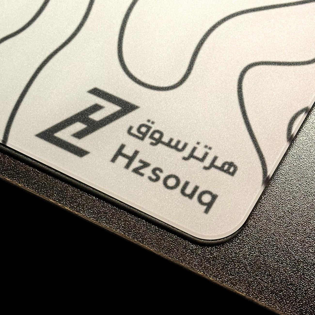 ماوس باد زجاجي Wave منظر قريب يعرض شعار هرتزسوق والسطح الزجاجي الأملس والأطراف المنحنية من هرتزسوق